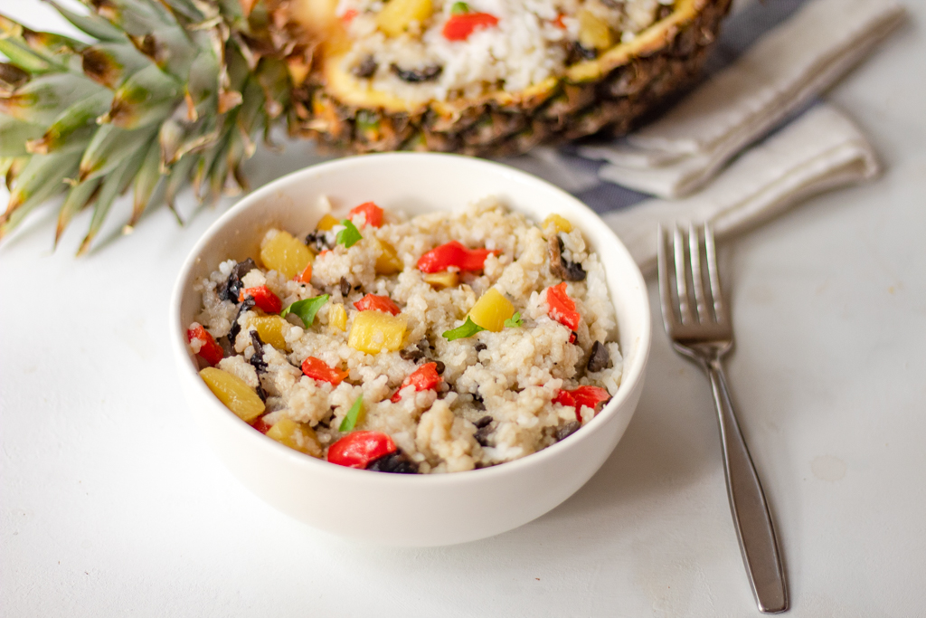 A white bowl with thai pineapple fried rice