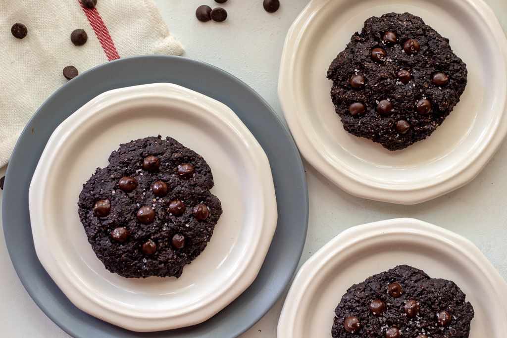 Three plates with a vegan chocolate cookie on each of them