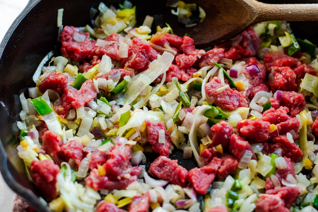 Skillet with meat and onions, garlic, and ginger