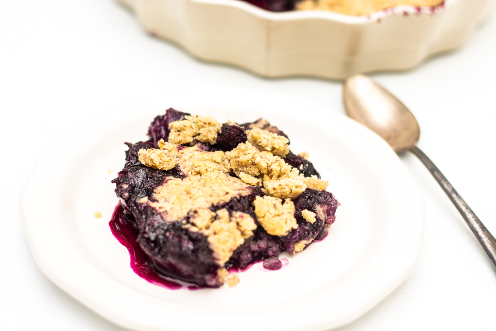 Vegan Gluten-free Blueberry Cobbler on a plate next to the pie plate